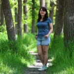 Entmology MSc student Crystal Almdal stands on a forest path.