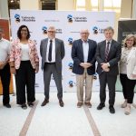 Six people who were involved in the June 27 announcement of SPOR funding stand on the stage in the Brodie Centre.