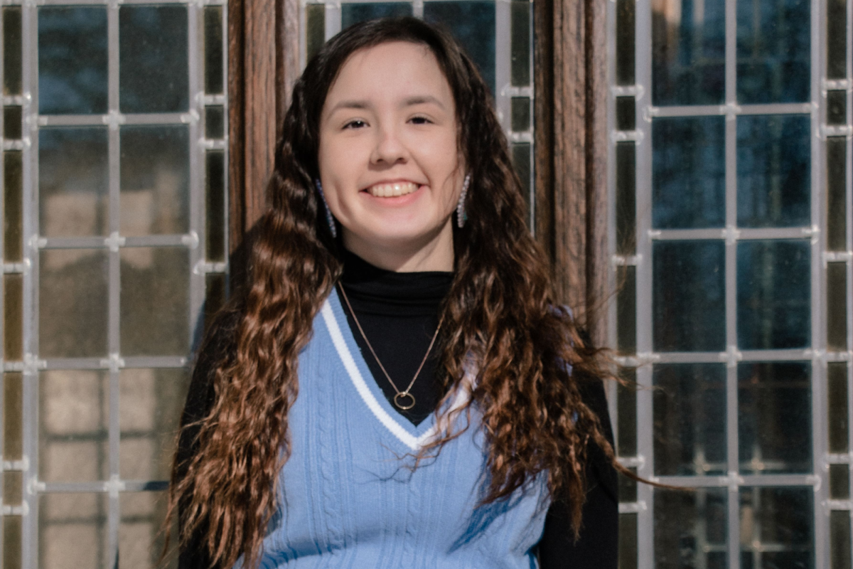 Photo of Raven Morrisseau sitting and smiling.