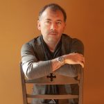 Rod Lastra sitting on a chair