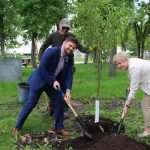 People planting a tree at UM Fort Garry campus.