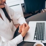 A woman is on a video call on her laptop computer with another person.