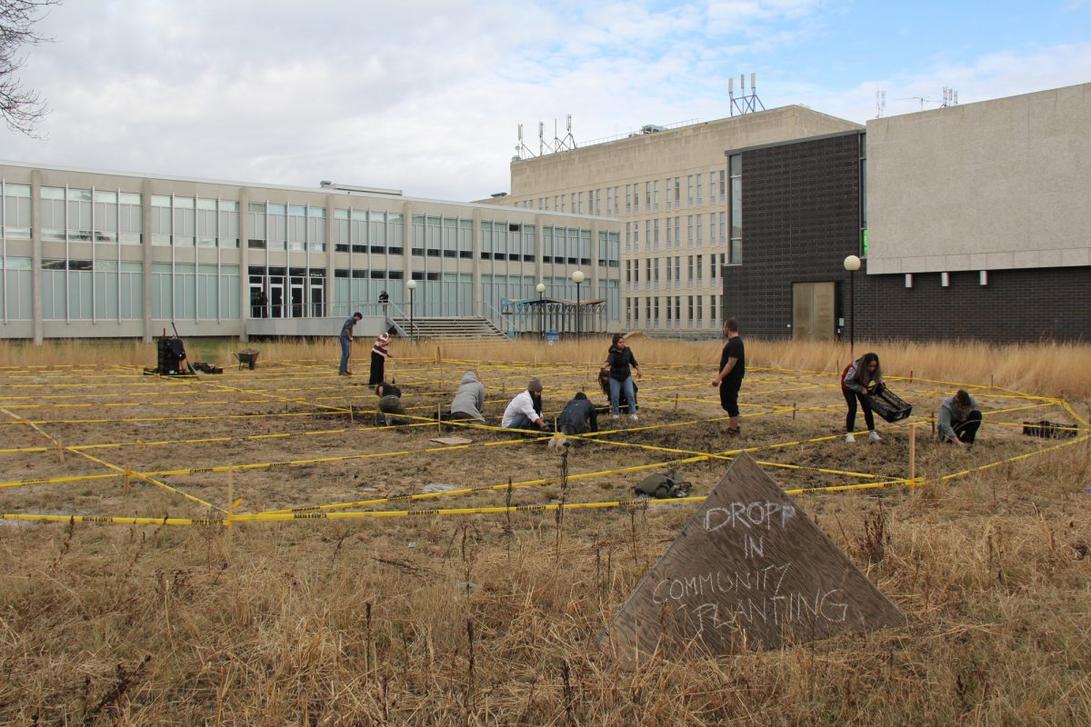 community participating in community planting in the front lawn of the John A. Russell Building