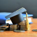 Photo of book, graduation cap, and toonies.