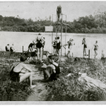 A historic black and white photograph of students swimming in vintage swimsuits.