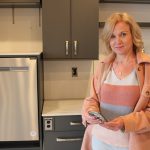 Jacquie Ripat in the smart suite kitchen with her smartphone.