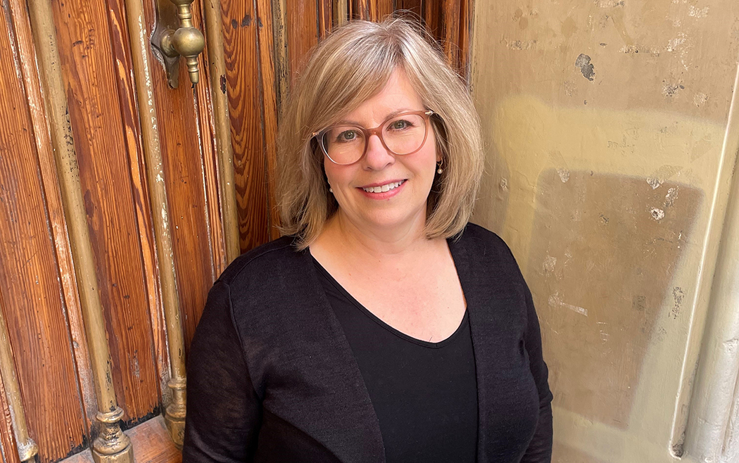 Monika Warren stands at a doorway.