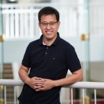 Man standing in front of a railing