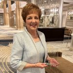Dr. Netha Dyck holding an award and smiling