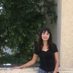 Kyla Wiens standing in front of limestone building.