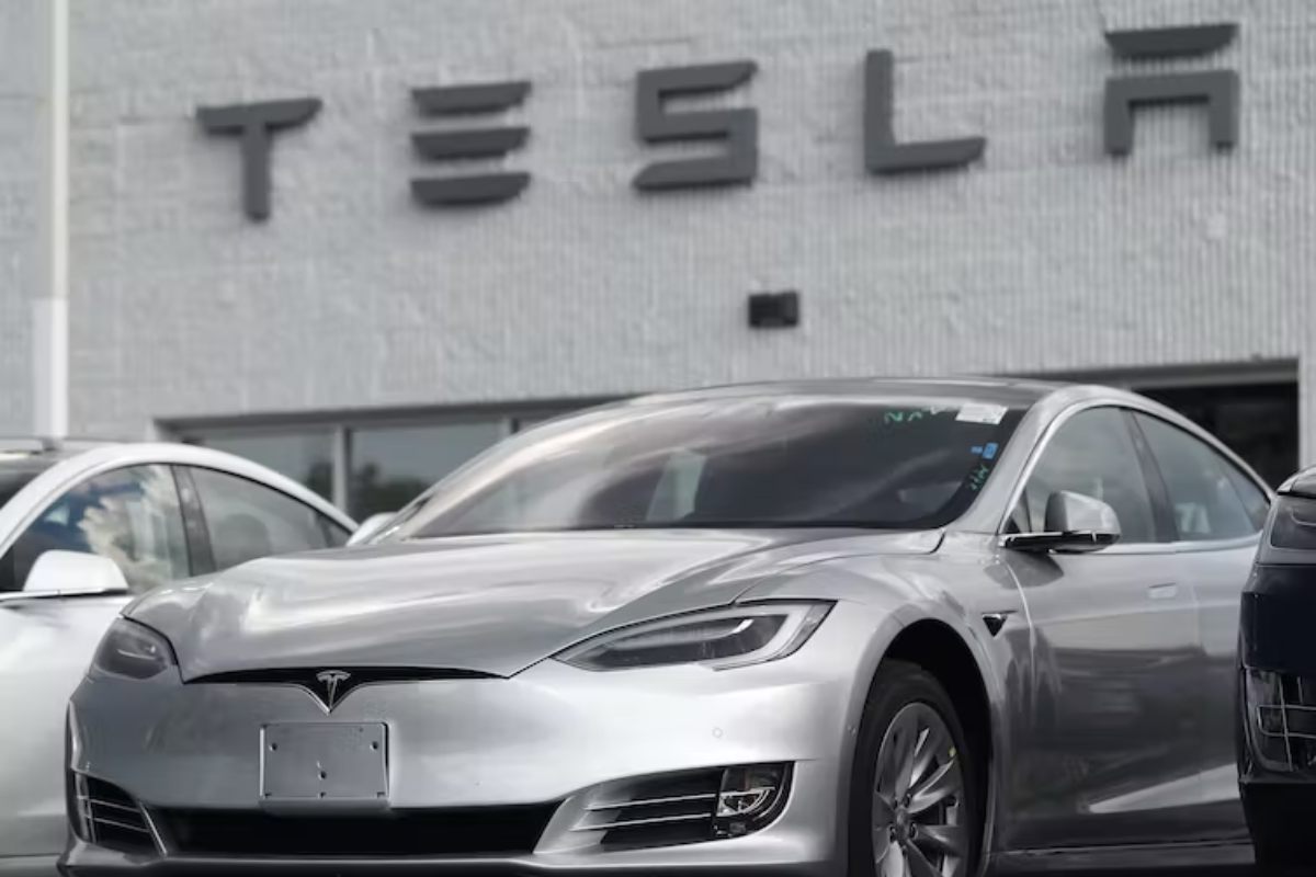 Tesla car in front of a Tesla dealership