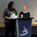 Dr. Marcia Anderson and Dr. Jillian Waruk stand at the podium at the Canadian Museum for Human Rights.