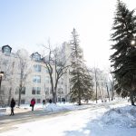 students walking outdoors on a sunny day in winter.
