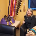 Knowledge Keeper Kim Guimond sitting on a chair in her office.