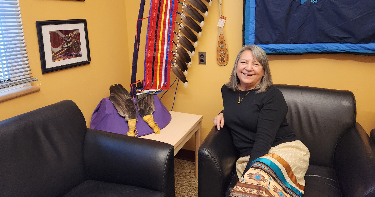 Knowledge Keeper Kim Guimond sitting on a chair in her office.