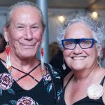 Two Two-Spirit leaders posing for a photo at an event.