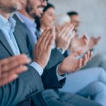 Seated audience members clapping.