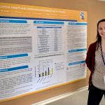 Kaitlin Reilly standing next to her poster