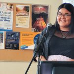 Qualico Bridge to Success student Demi Quill giving a speech at a podium