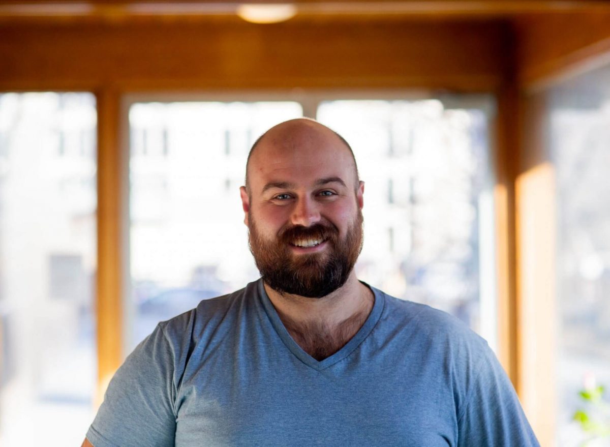 Ryan Turnbull smiles in a portrait photo.