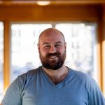 Ryan Turnbull smiles in a portrait photo.