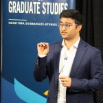 Keshav Narayan Alagarsamy gives his presentation. A banner behind him reads "Faculty of Graduate Studies" and umanitoba.ca/graduate-studies".