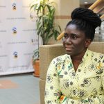 Vera Anokyewaa Amponsah sitting in the College of Nursing building, looking thoughtful.