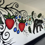 Mural of floral motif and black bear painted in hallway