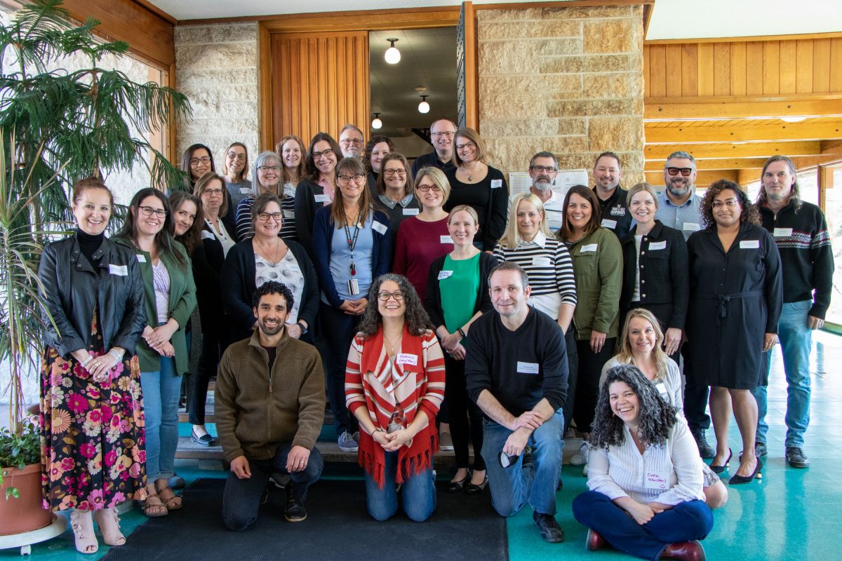 Group of instructors smiling for a posed photograph.