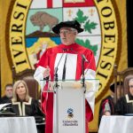 Dr. Thomas Quinn speaking at the podium at Convocation.