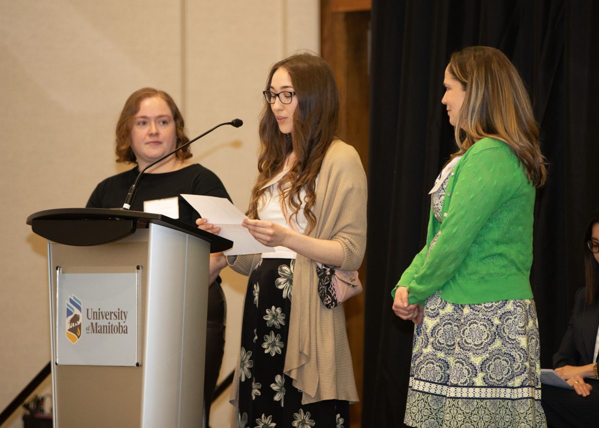 3 people presenting at the Students' Teacher Recognition Reception.