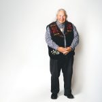 Murray Sinclair poses against a white wall.