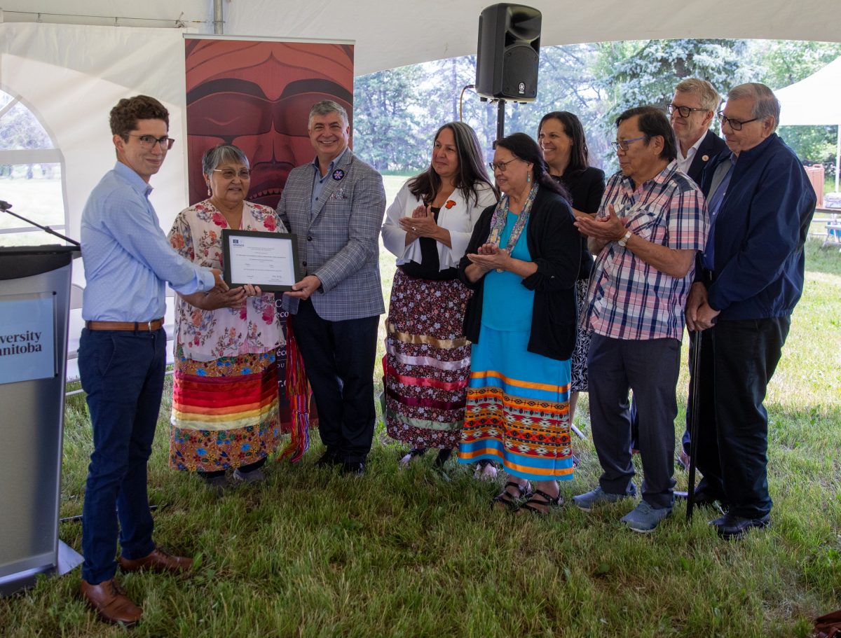 UNESCO's Cody Groat presenting certificate to NCTR staff, Elders and Survivors on June 29, 2023