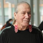 Two-Spirit Métis Elder Charlotte Nolin poses for a photo at an event.