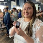 Winter Traverse poses with her College of Nursing pin inside the Pinnacle Club.