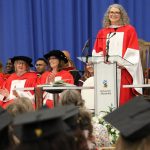Jen Gunter stands at a podium addressing graduates at convocation.
