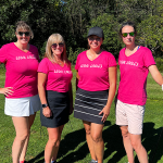 Group of faculty and staff members posing for photo at golf course