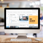 Computer screen on a desk with New Aurora launch page on the screen. The background is blurred out sunny classroom