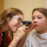 Physician examines a child's ear.
