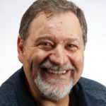 portrait of man with beard smiling at the camera