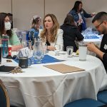 Three Teaching Café attendees having a discussion.