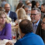 Faculty and staff around a table at the 2023 Long Service Awards.