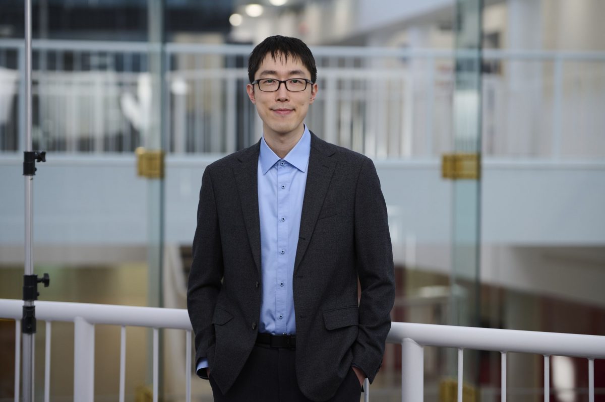Man standing in front of a railing.