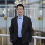 Man standing in front of a railing.