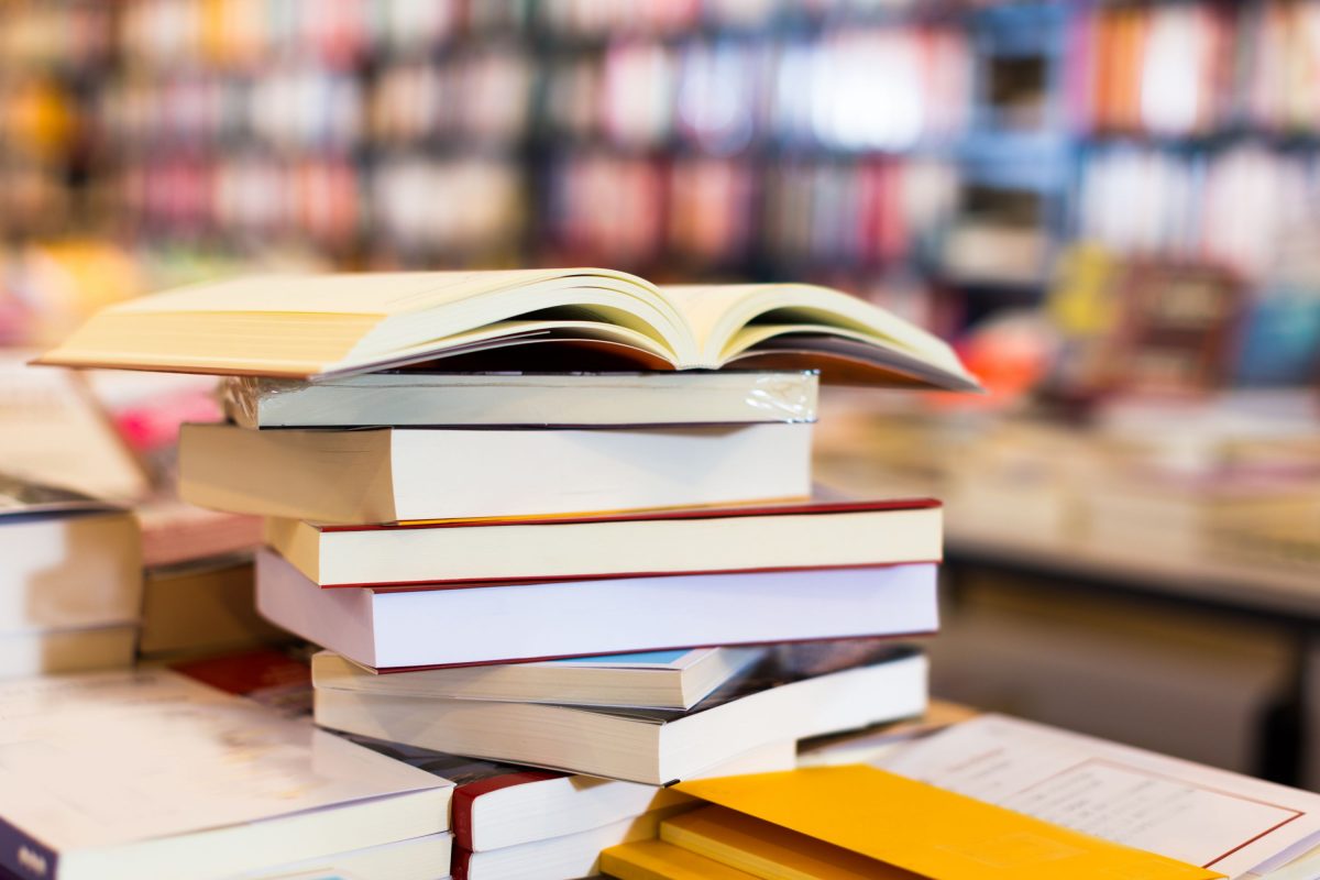 Stack of books on a table in a bookstore.