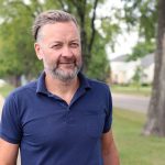 Dr. Jonathan McGavock walks on an outdoor pathway.