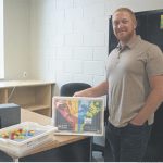 Michael Barker holding a Lego set