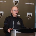 Alex Gardiner speaking at an alumni event