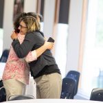 Two attendees of the 2023 SoTL Symposium embrace.