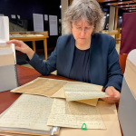 Shelley Sweeney looks over the Peter Hugh Aykroyd fonds in the University of Manitoba archives and special collections room. (Darren Bernhardt/CBC)